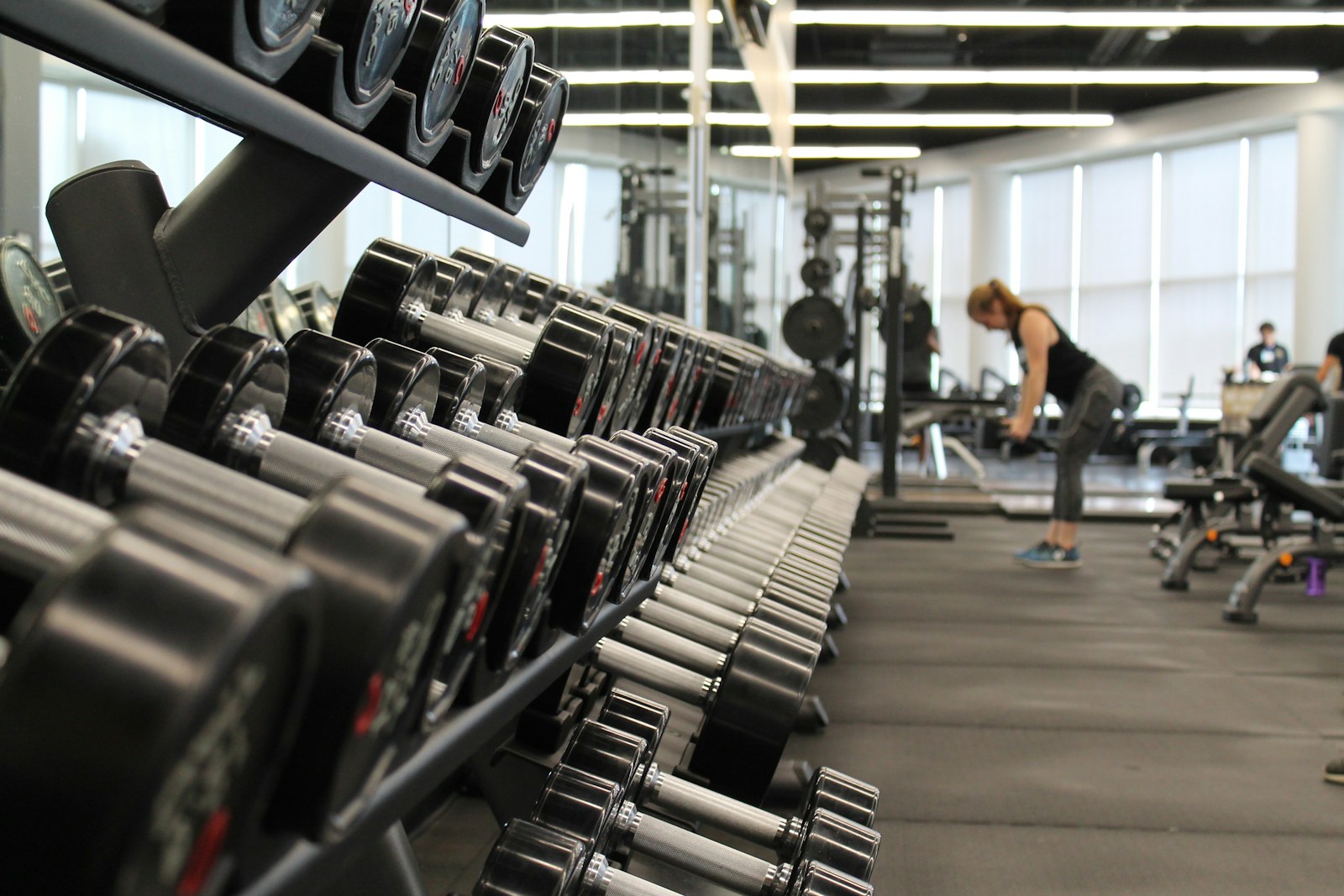 A bright home workout space with dumbbells and an exercise mat
